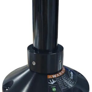 Black industrial equipment with warning label.